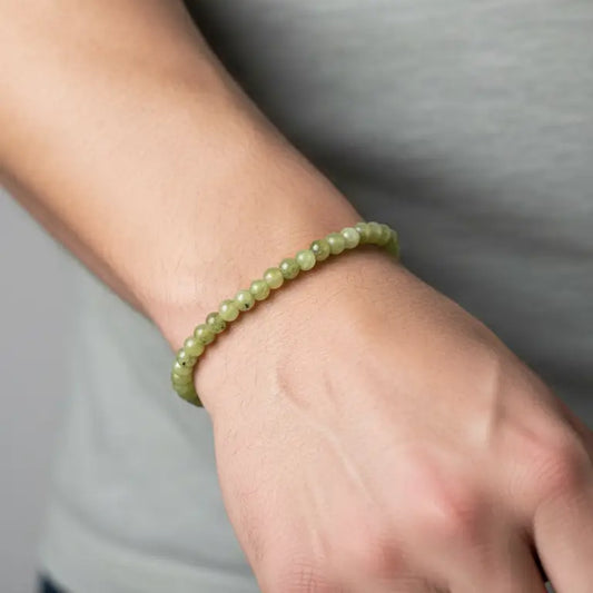 Peridot Beaded Bracelet on a wrist and light grey background